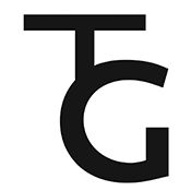 Simple logo featuring "TG" in black text on a white background. The T is partially hidden behind the G.